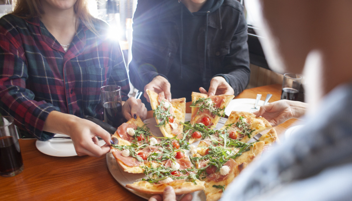 Students eating pizza.