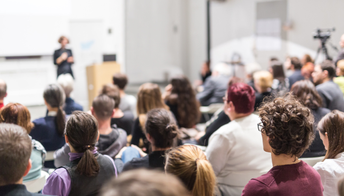 Group of people listening to presentation.
