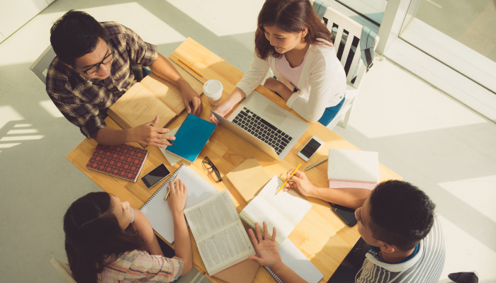Students sitting around table.
