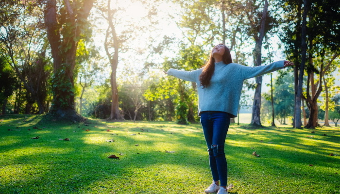 Student standing in the park relaxing.