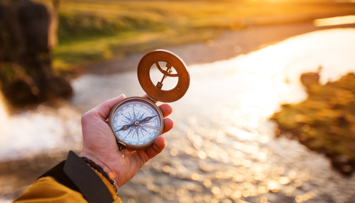 Person holding a campass.